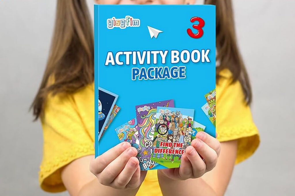 a child holding a small activity book