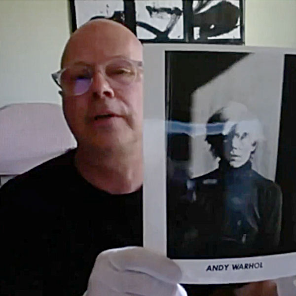 Donald Warhola holding a photo of his uncle, Andy Warhol