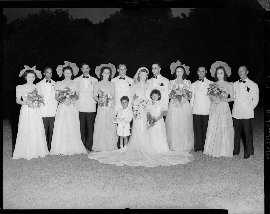wedding party posed in front yard