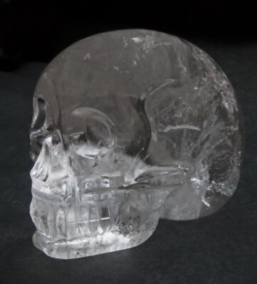 a crystal skull on a black background.