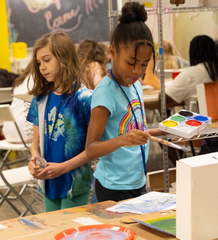 children doing art projects in a studio space