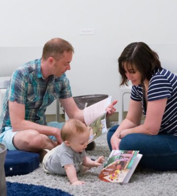 A family with small child read books together