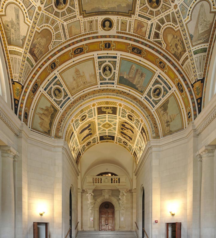 an elaborate domed ceiling in an arched hallway