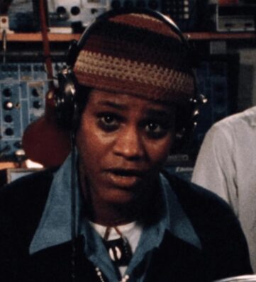 A person in a knit hat wearing headphones