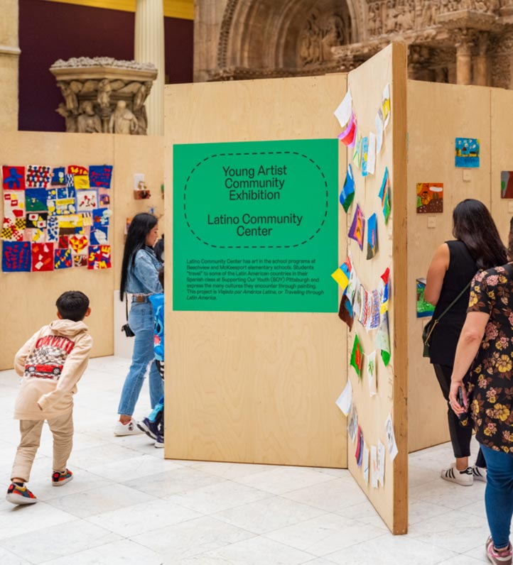 Exhibition showcasing colorful artworks with visitors engaging in the displays.