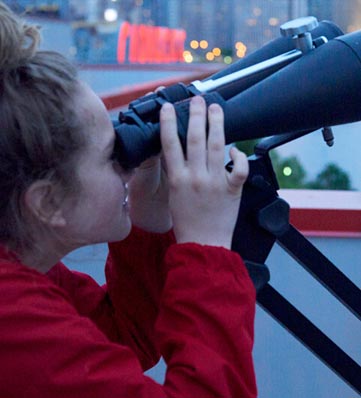 woman looking through binoculars
