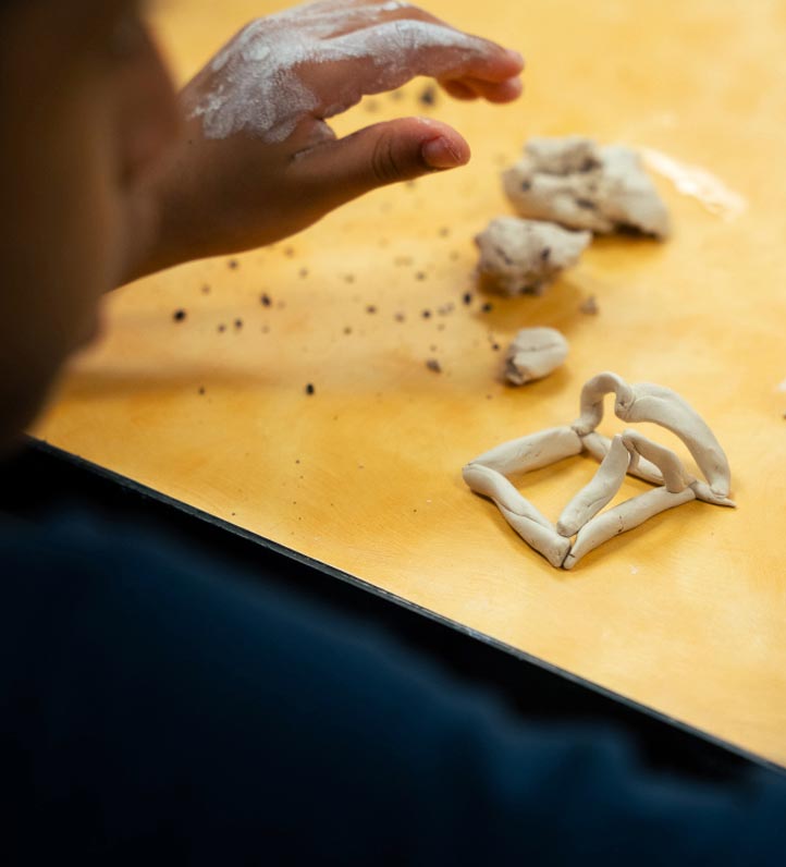 kid working with clay