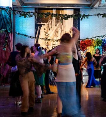 young people dressed up and dancing in a museum setting