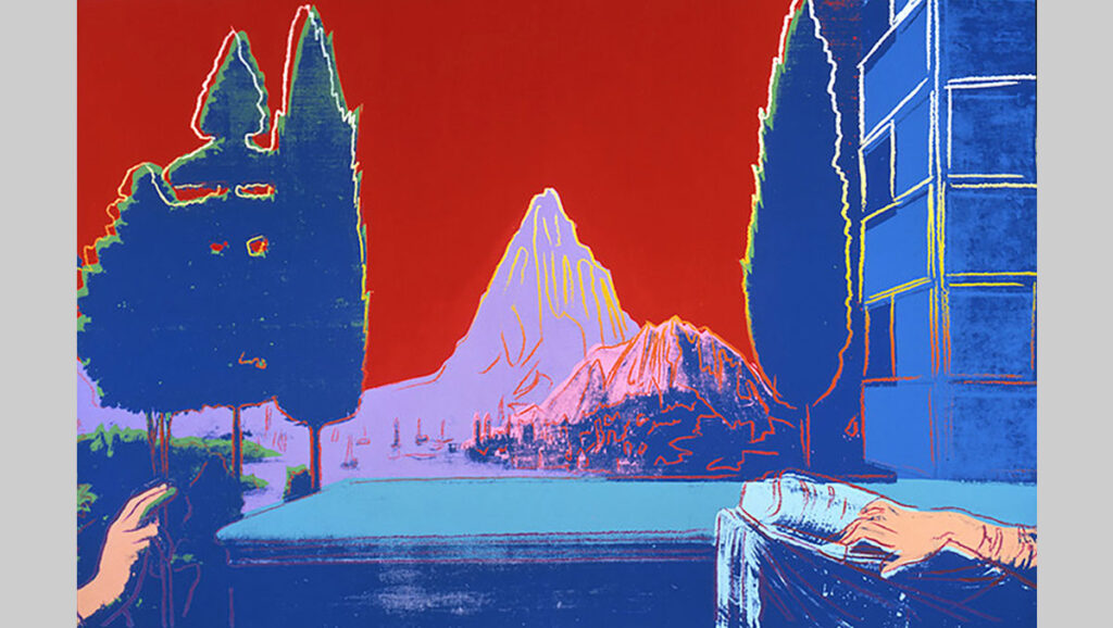 A vibrant scene featuring mountains and trees against a bold red backdrop, with hands resting on a blue table.