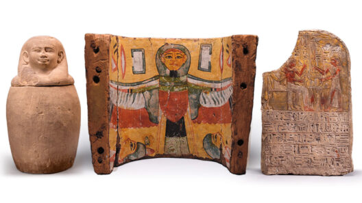 Ancient artifacts including a ceramic jar, a vividly painted wooden panel, and a carved stone depicting hieroglyphics and figures.