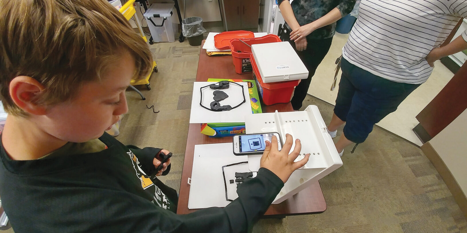 a child using a tactile-assisted device