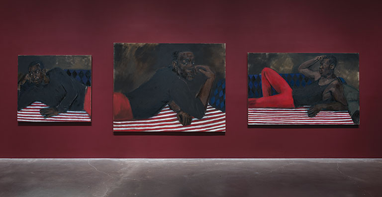 Gallery view of 3 paintings of african-american men against a red wall.
