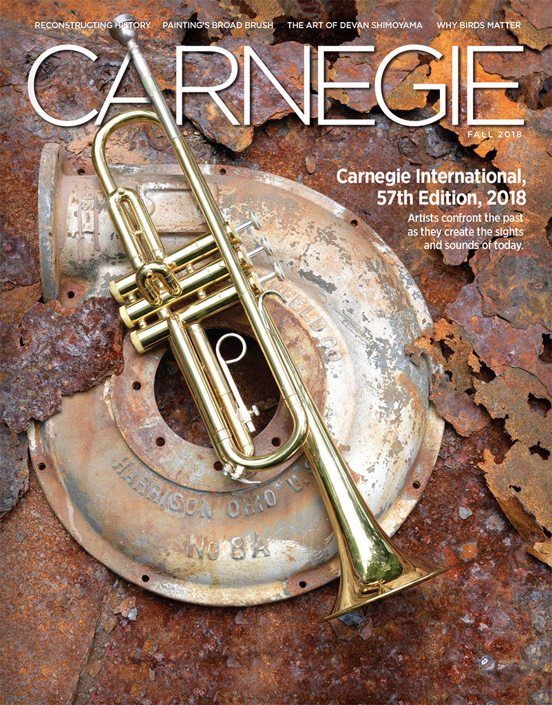 Cover of magazine showing a trumpet laying on top of a pile of rusted metal.