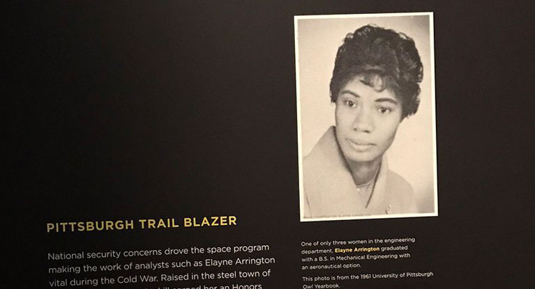 A display at teh University of Pittsburgh with a 1961 college yearbook photo of Elayne Arrington.