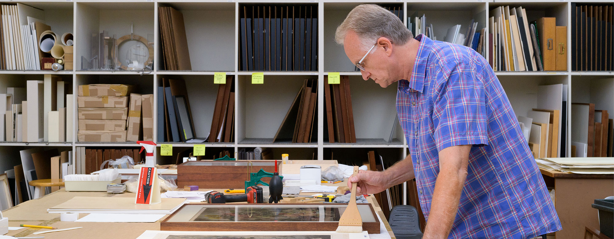 Portrait of Dale Luce at work in the Carnegie Museum of Art's framing room.