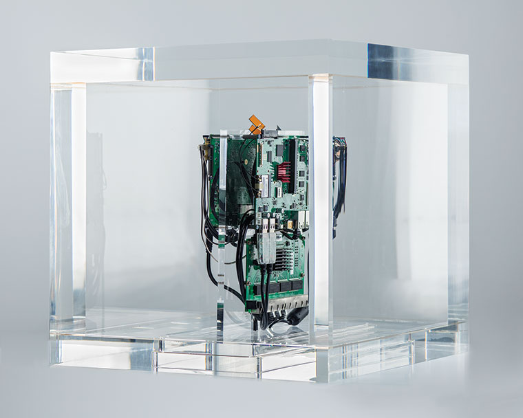 A plexiglass box containing a computer component.