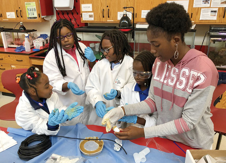 A group of young girls working in a lab.