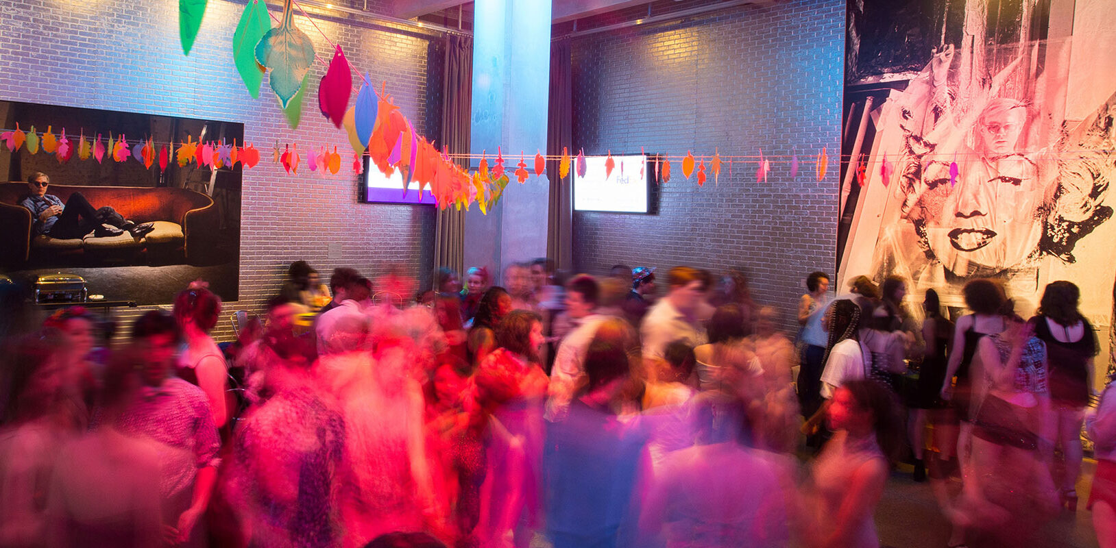 A blurred image of a group of teens dancing