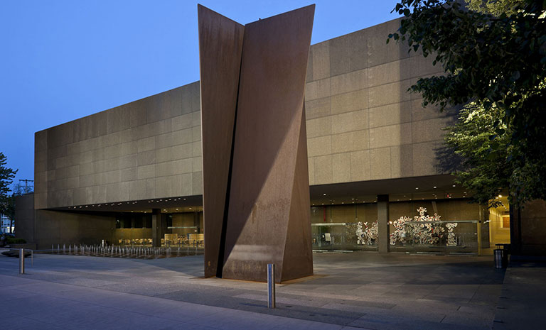 A photo fo the exterior front of Carnegie Museum of Art with a steel structure in front of the building