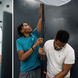 2 young men assembling a light fixture