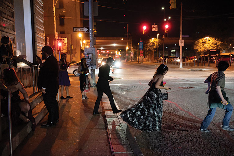 Prom goers leaving the Warhol museum at night.