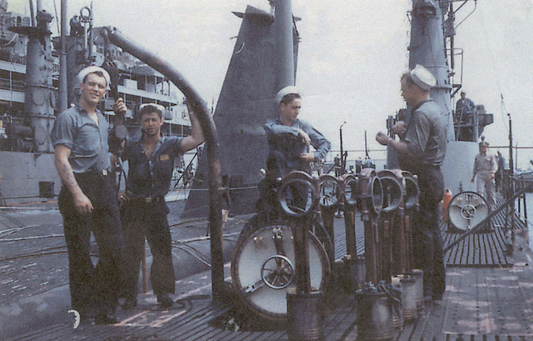 a vintage photo of the crew of a submarine standing on it's deck