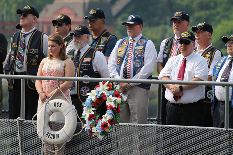 a memorial service on the deck of a submarine.