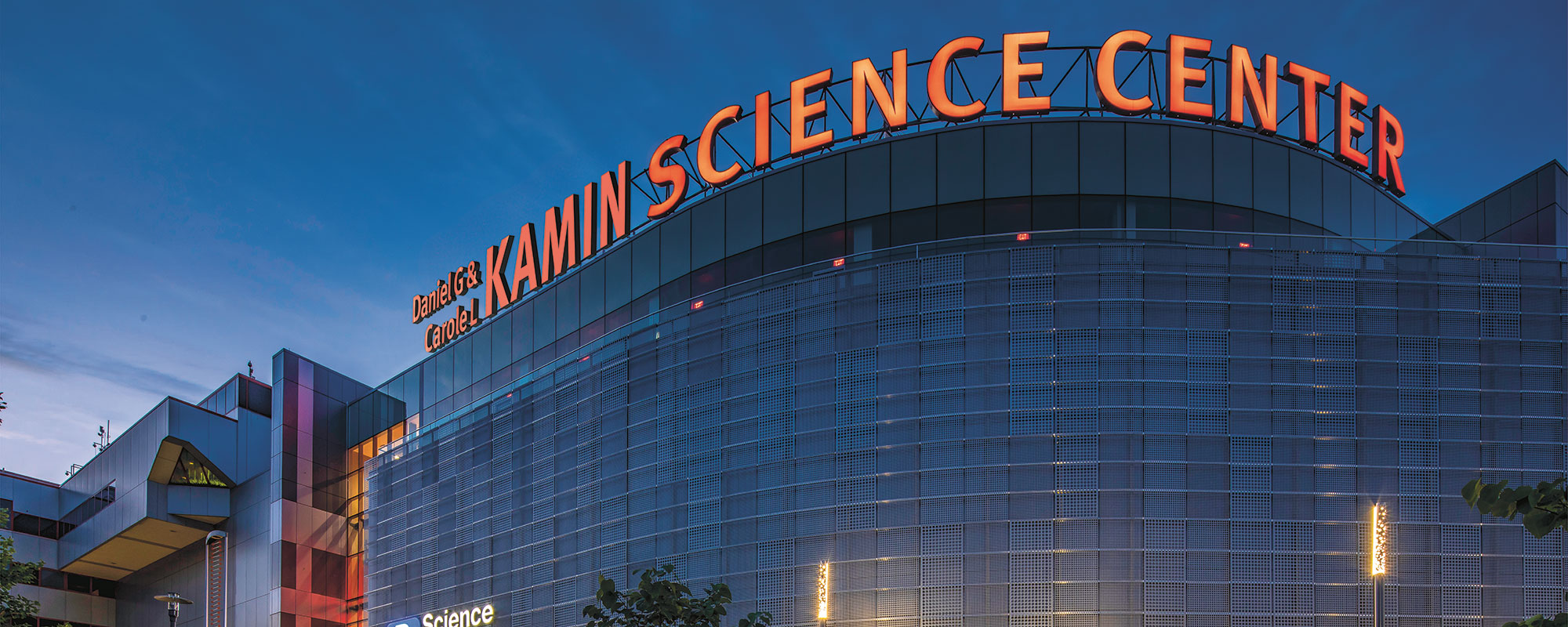 An exterior view of the science center building with the new Kamin Science Center letters around the top of the building.