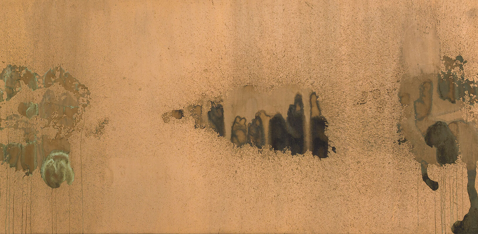 A large piece of artwork with abstract shapes printed in dark colors against a copper background.