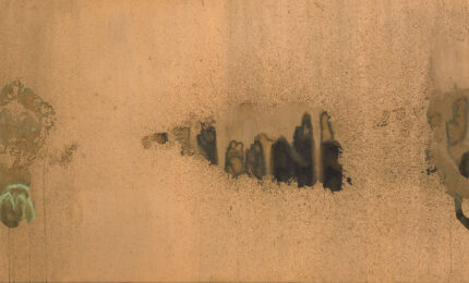 A large piece of artwork with abstract shapes printed in dark colors against a copper background.