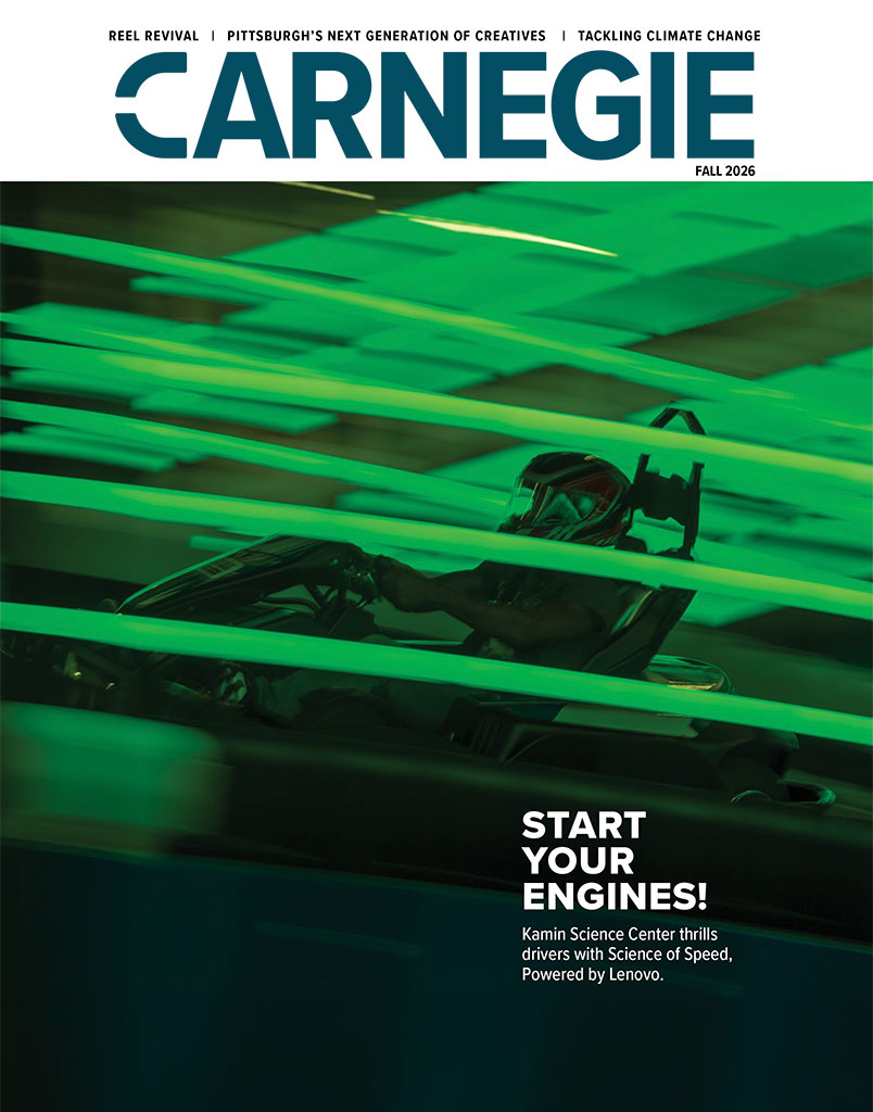 Carnegie Fall 2026 magazine cover: helmeted driver in a race car amid vivid green motion blur, with bold text, “Start Your Engines!”