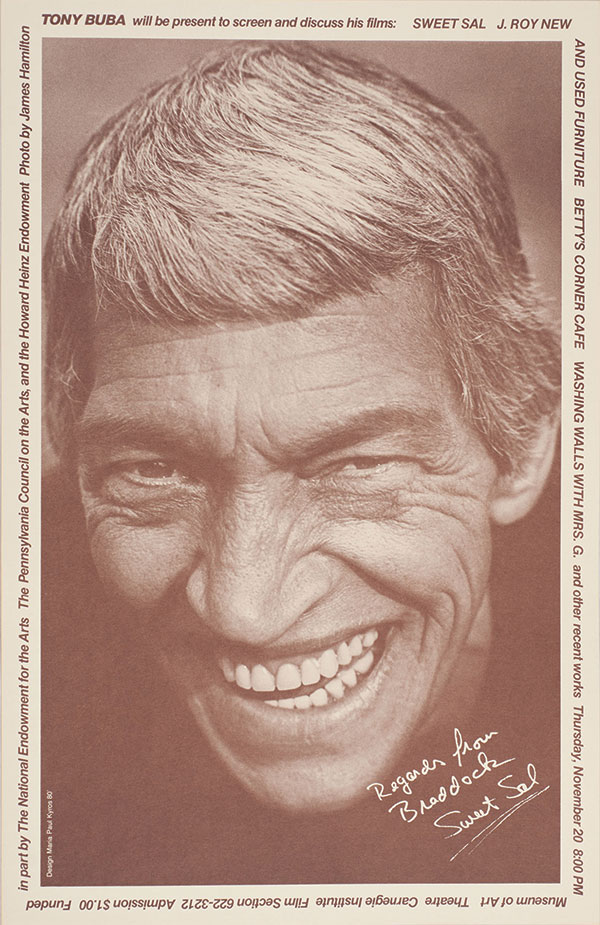Sepia-toned poster with a close-up portrait of a smiling, squinting man, tousled hair, handwritten dedication, and film-screening text.