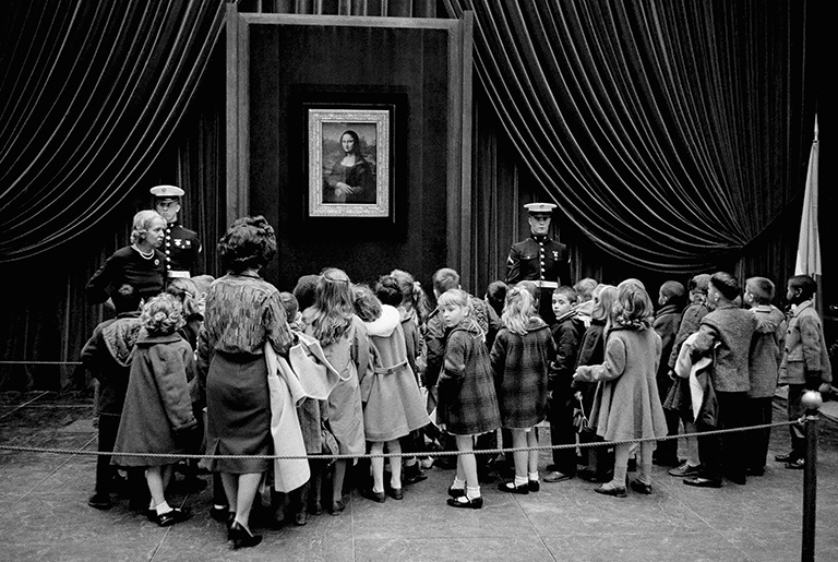Vintage photo of visitors in line to see Mona Lisa in 1963.