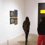 Two teenage girls walking in a gallery at the Andy Warhol museum