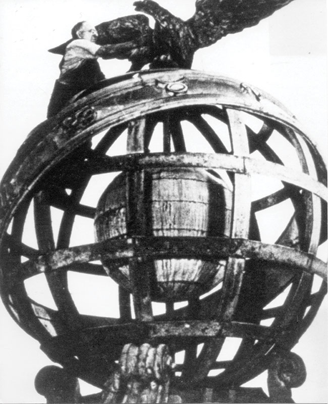 A man working on a large sphere