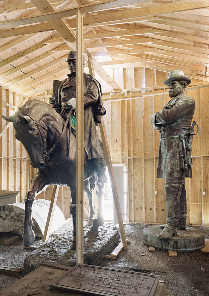 Two statues of confederate soldier in a small storage shed