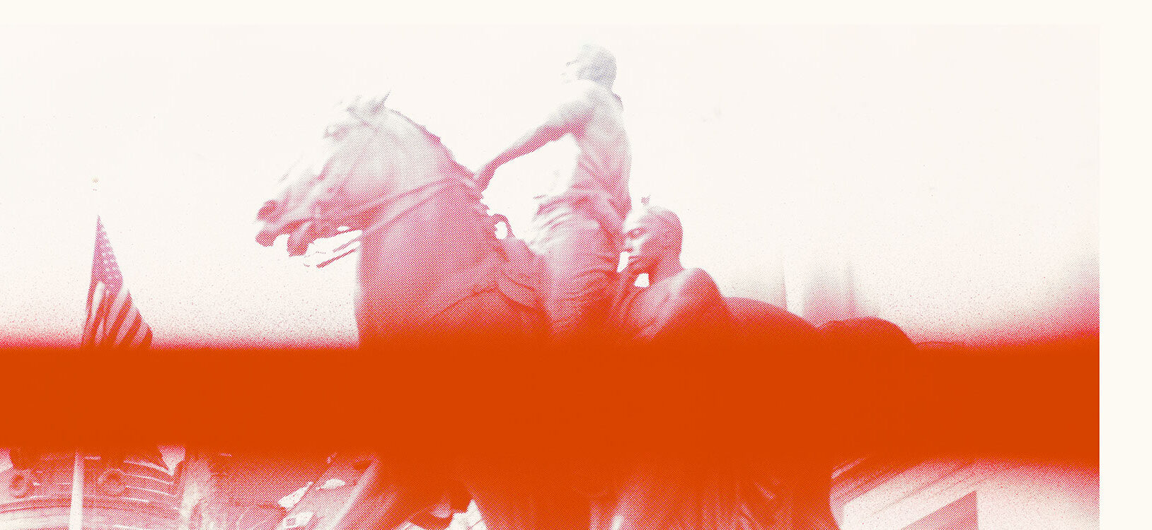 A photo of a sculture of a man on a horse with another man walking beside him. The photo has a large blurred red line across it.