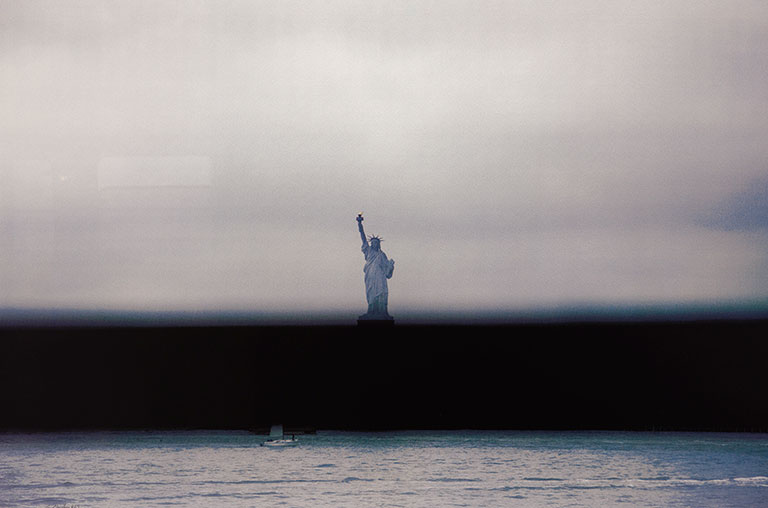View of the Statue of Liberty with a blurred black line through it.