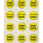 A series of yellow stickers that read, Bomb Hanoi.