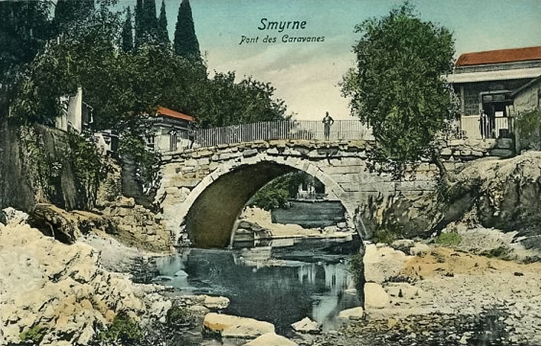 An old postcard depicting a stone bridge across a river