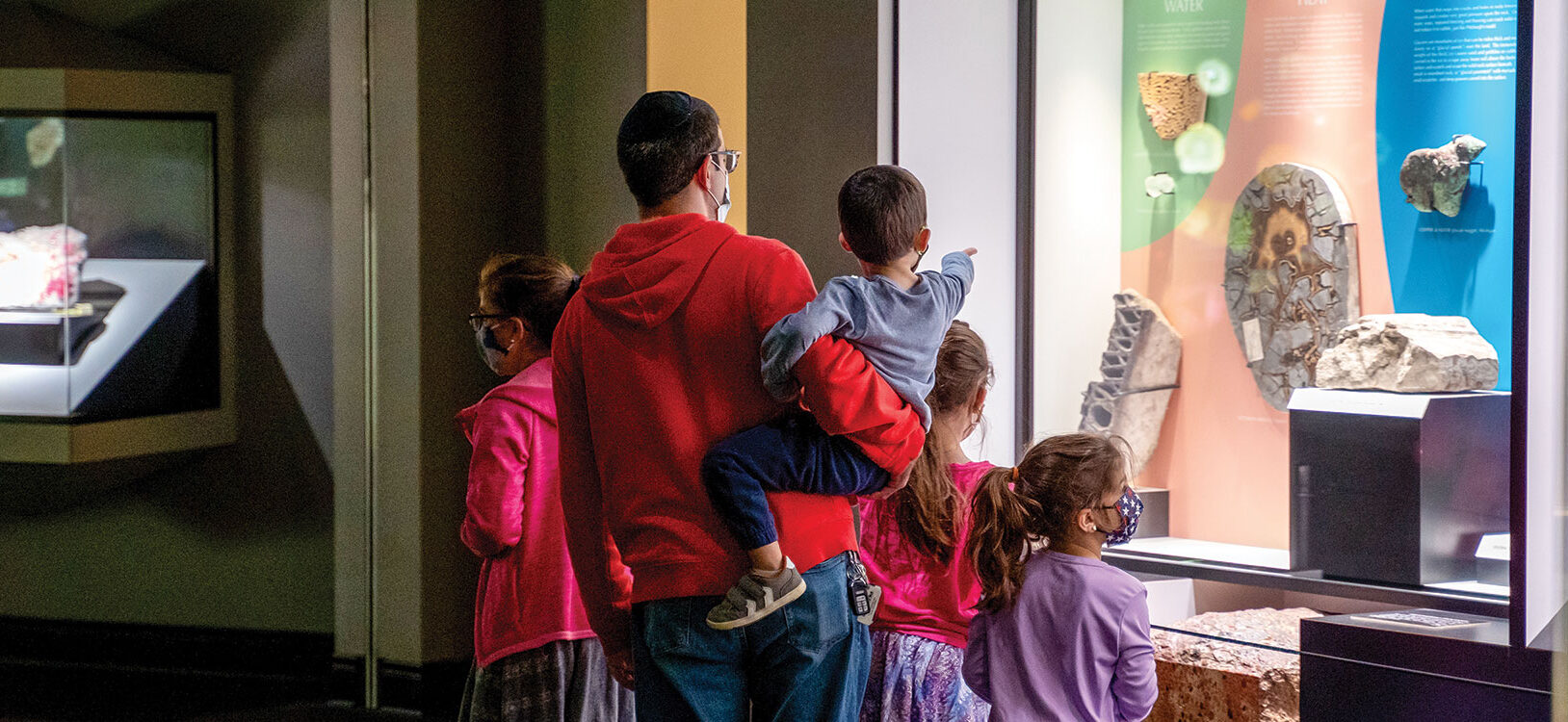 A family walking though a quiet museum gallery