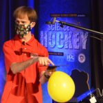 A man demonstrating a science experiment about hockey