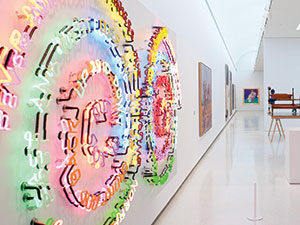 An gallery installation view of a colorful neon artwork