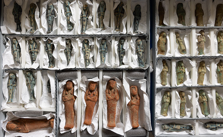 Rows of small hand carved figures.