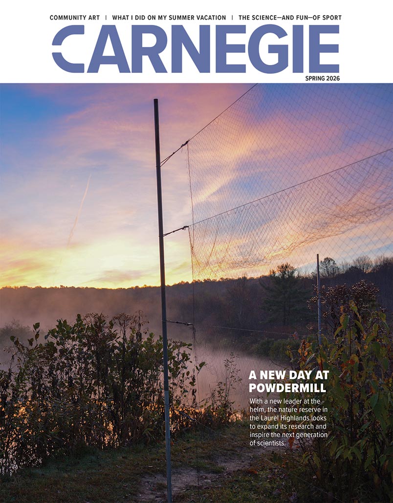 Cover of Carnegie Magazine, Spring 2026. Features a serene sunrise over a misty landscape with trees and a net fence. Text: "A New Day at Powdermill."