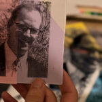 Ian Gallagher holds a print of his late father, Peter.