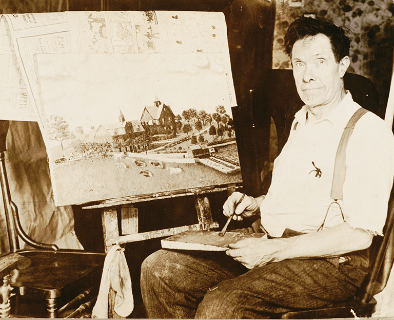 artist sitting in front of an easel working on a painting
