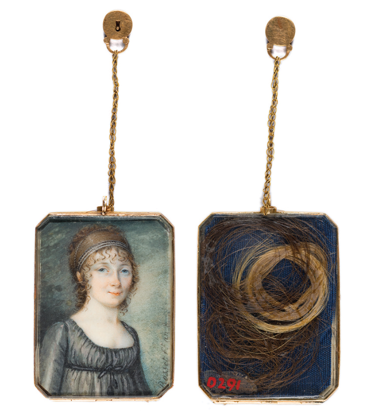 locket with painting of a young woman's face on one side and a lock of hair in the other.