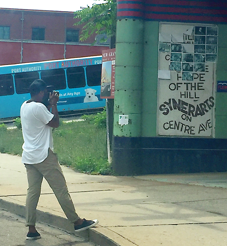 Man taking photograph of an old abandoned theater.