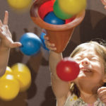 A group of small children laughing and playing at the Carnegie Science Center